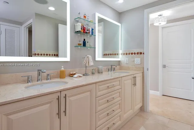 a bathroom with double sink and a mirror