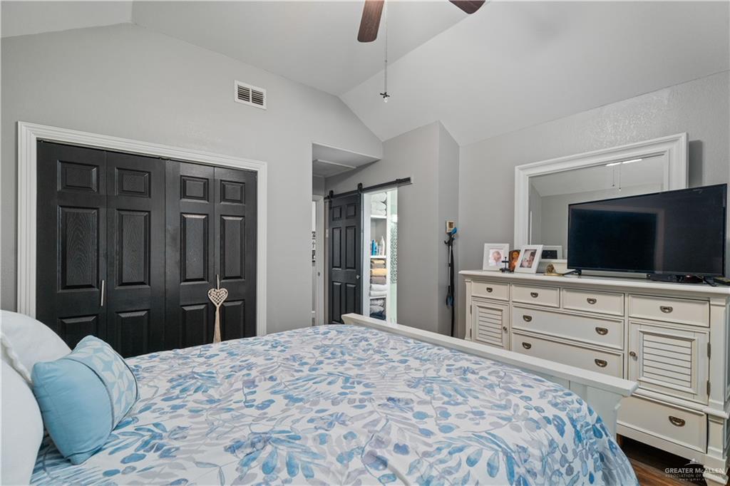 718 Hummingbird Avenue Pharr, TX 78577 - Photo 11 of 13 a bedroom with a bed and a flat screen tv in it