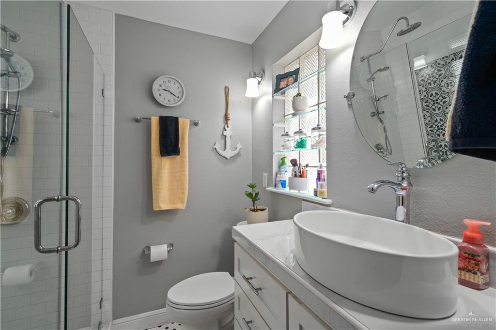 718 Hummingbird Avenue Pharr, TX 78577 - Photo 12 of 13 a bathroom with a sink a toilet and shower