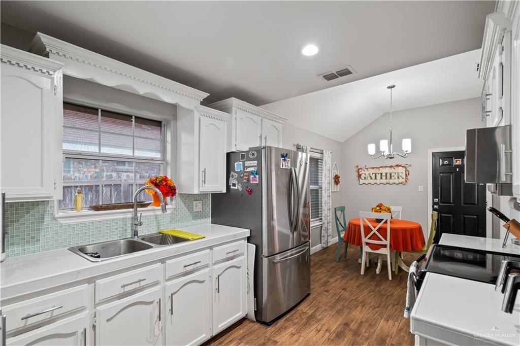718 Hummingbird Avenue Pharr, TX 78577 - Photo 5 of 13 a kitchen with stainless steel appliances a refrigerator and a wooden cabinets