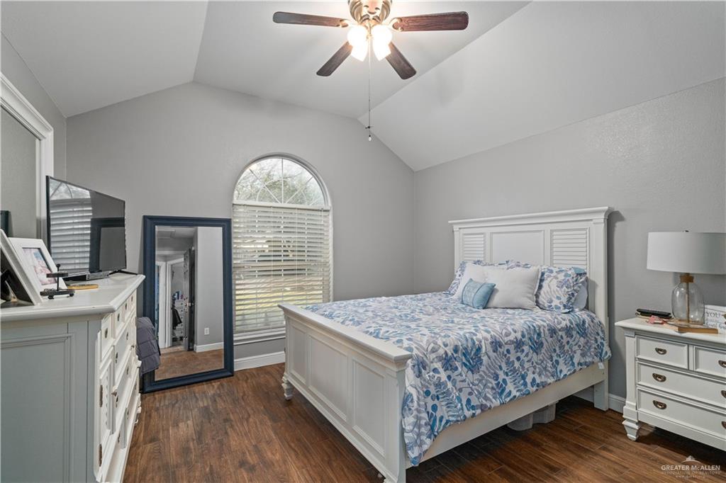 718 Hummingbird Avenue Pharr, TX 78577 - Photo 10 of 13 a bedroom with a large bed and a chandelier