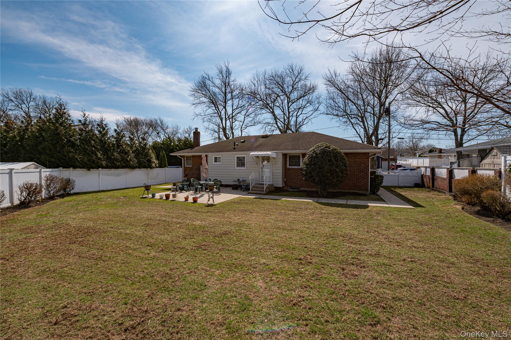 23 Olga Lane Commack, NY 11725 - Photo 13 of 17 a backyard of a house with table and chairs