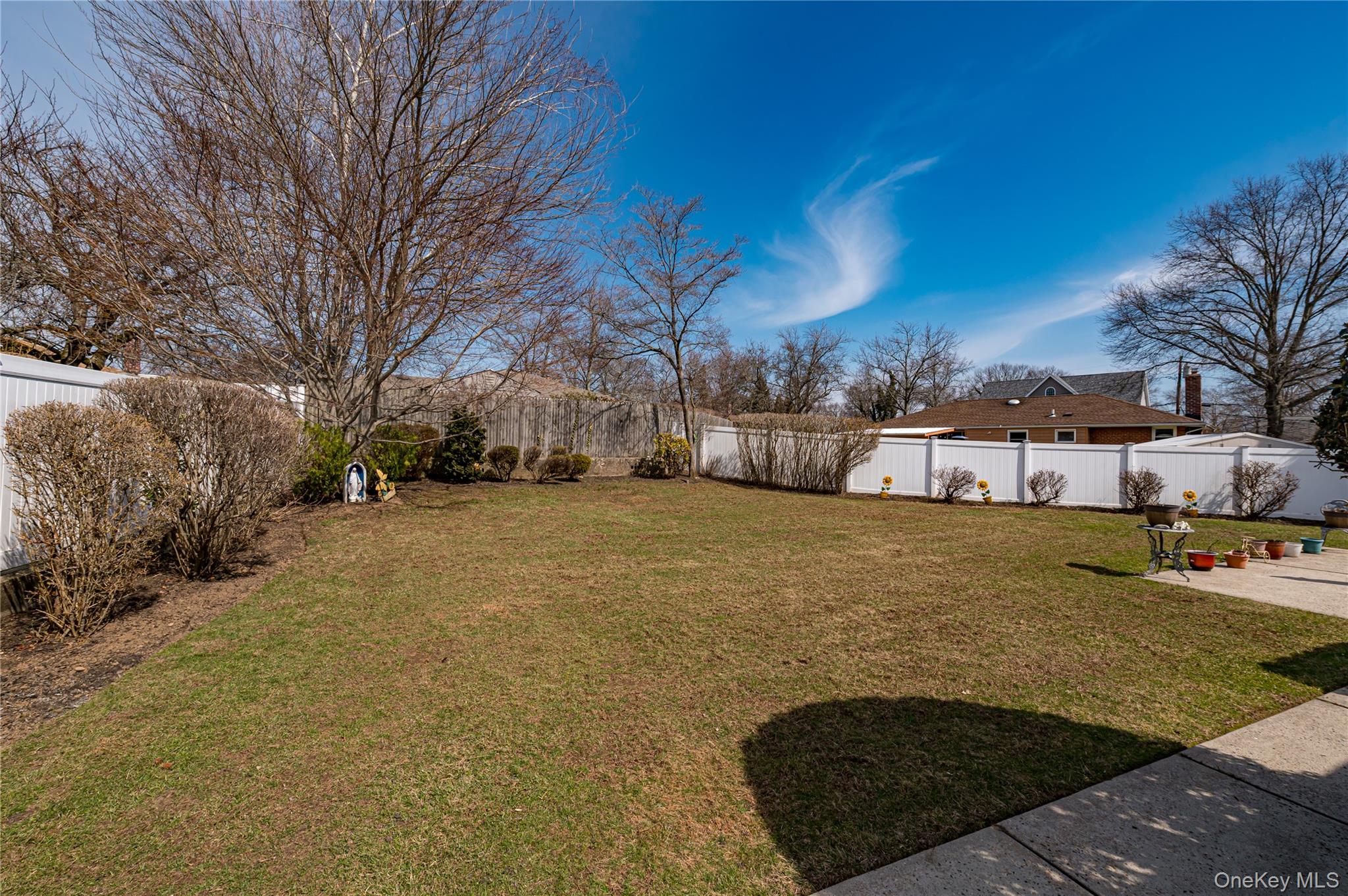 23 Olga Lane Commack, NY 11725 - Photo 16 of 17 a view of a yard with cars