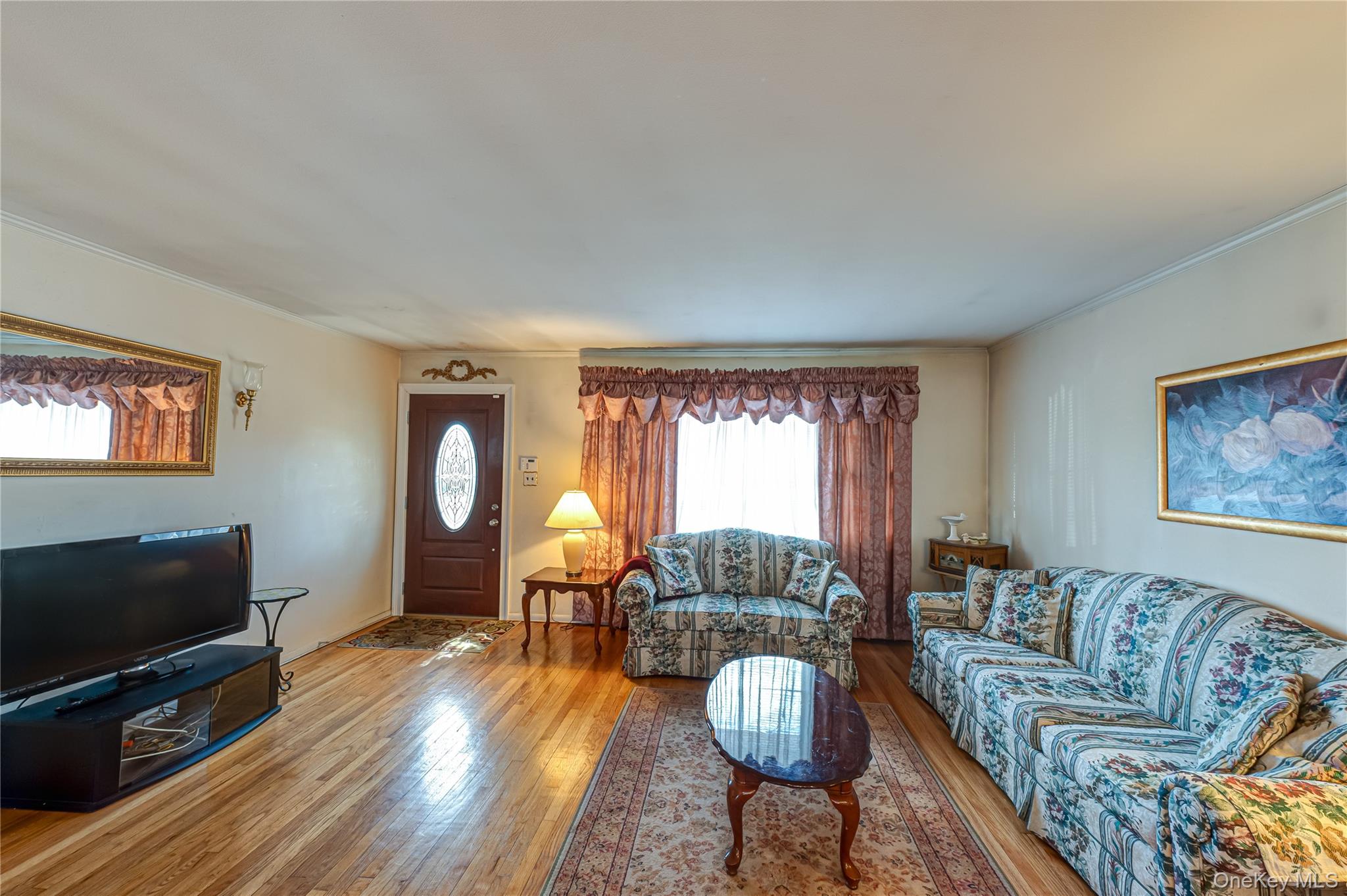 23 Olga Lane Commack, NY 11725 - Photo 4 of 17 a living room with furniture and a flat screen tv
