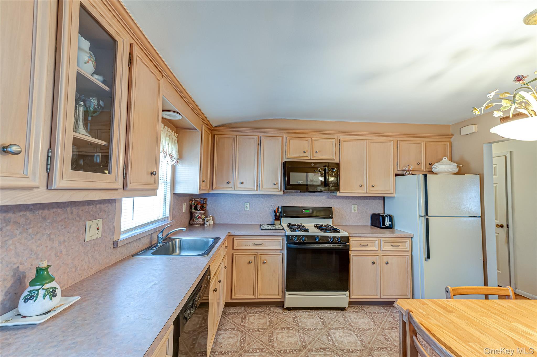 23 Olga Lane Commack, NY 11725 - Photo 6 of 17 a kitchen with a sink a refrigerator and a stove top oven