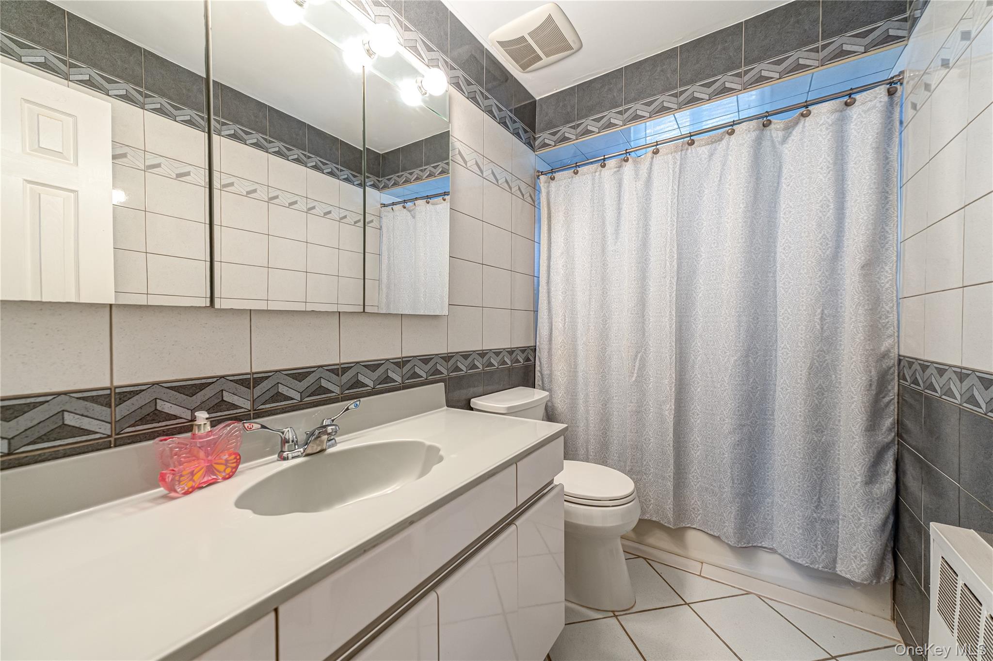 23 Olga Lane Commack, NY 11725 - Photo 8 of 17 a bathroom with a sink and a mirror