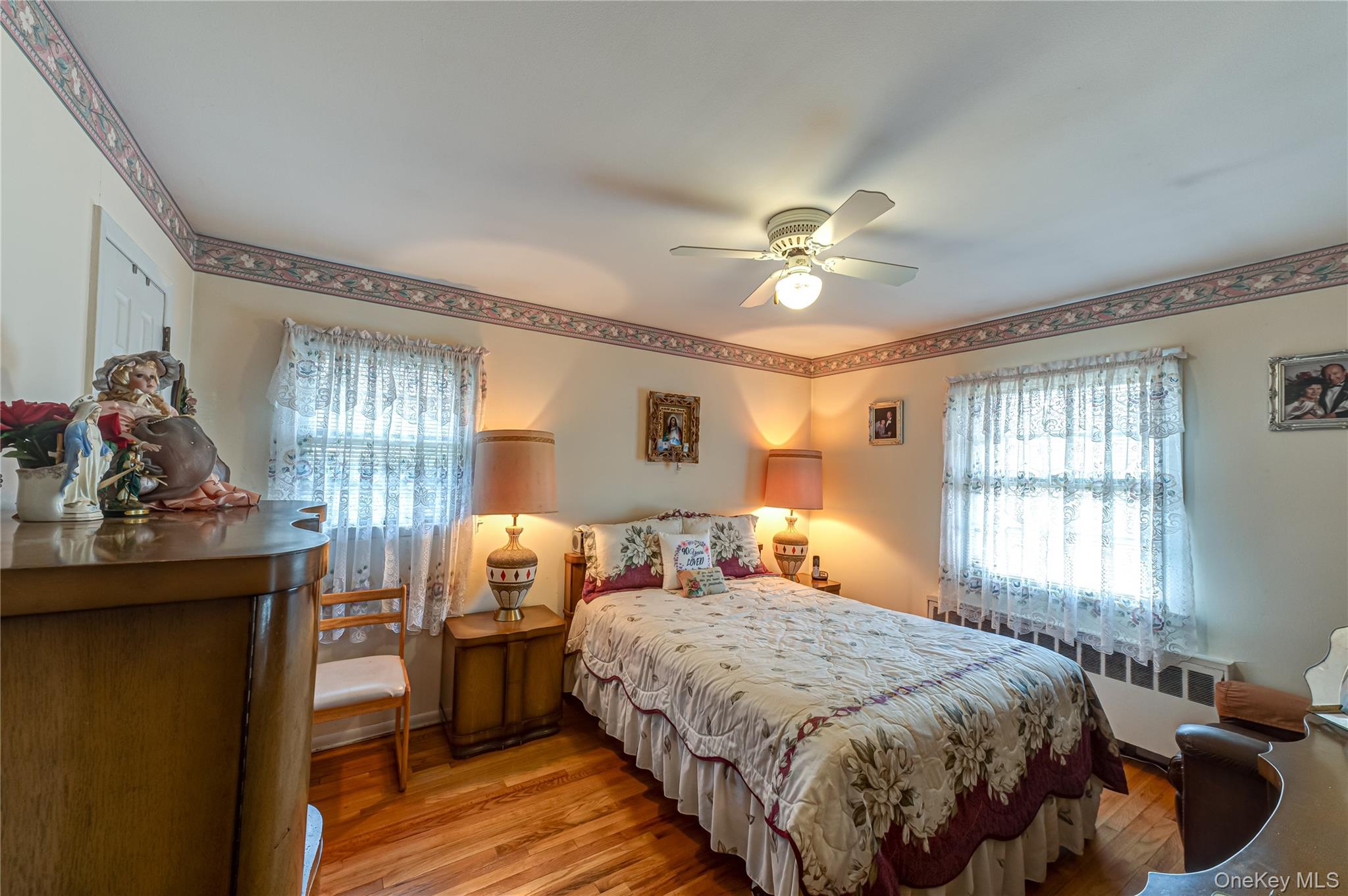 23 Olga Lane Commack, NY 11725 - Photo 9 of 17 a bedroom with a bed and a chandelier