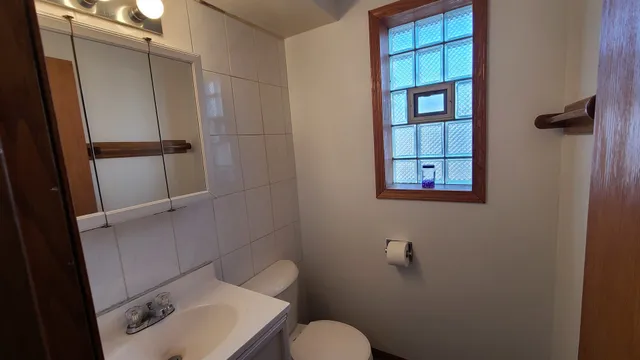 a bathroom with a toilet sink and shower