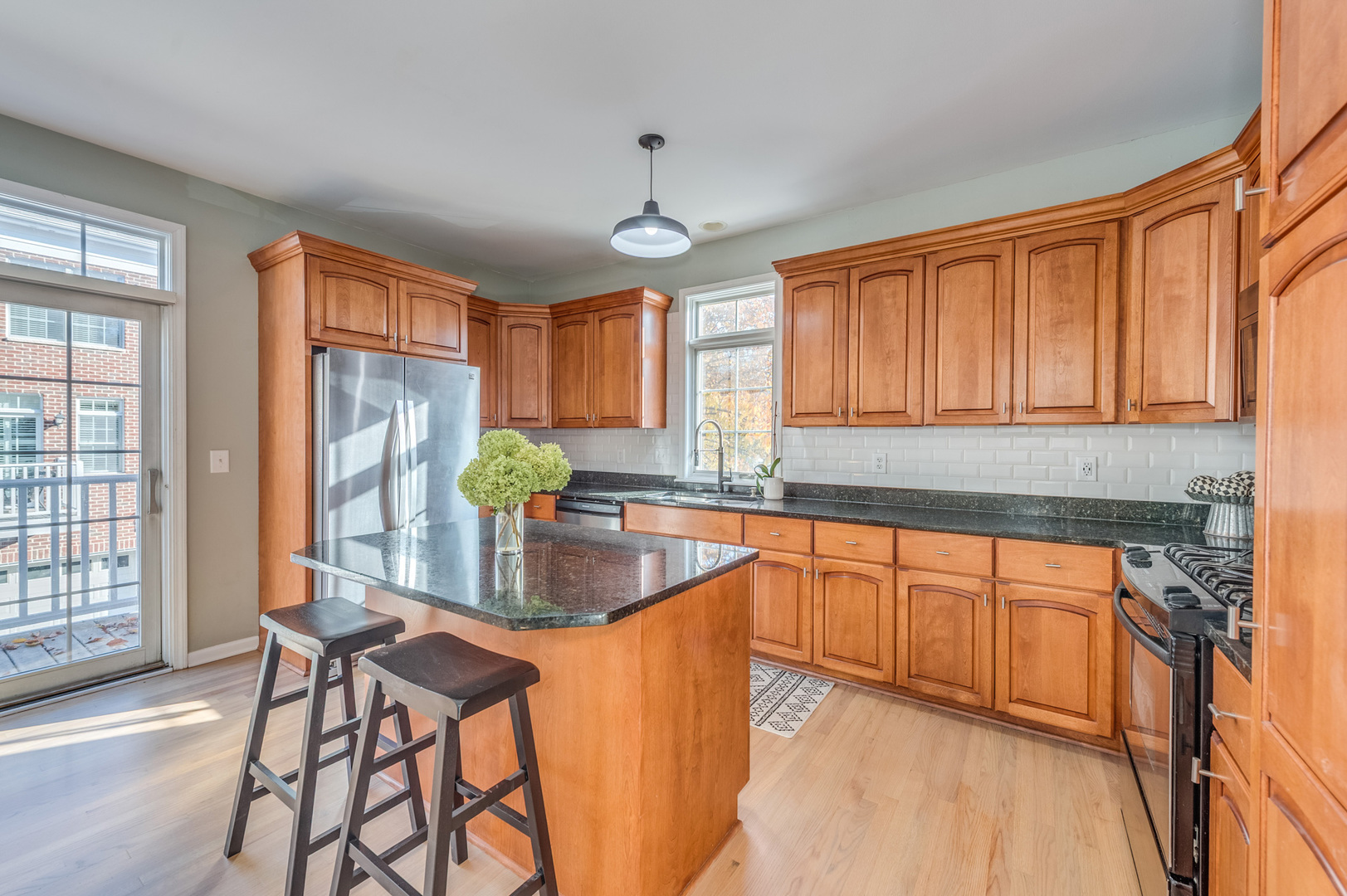 243 Boxcar Avenue Naperville, IL 60540 - Photo 11 of 29 a kitchen with stainless steel appliances granite countertop sink stove top oven and cabinets