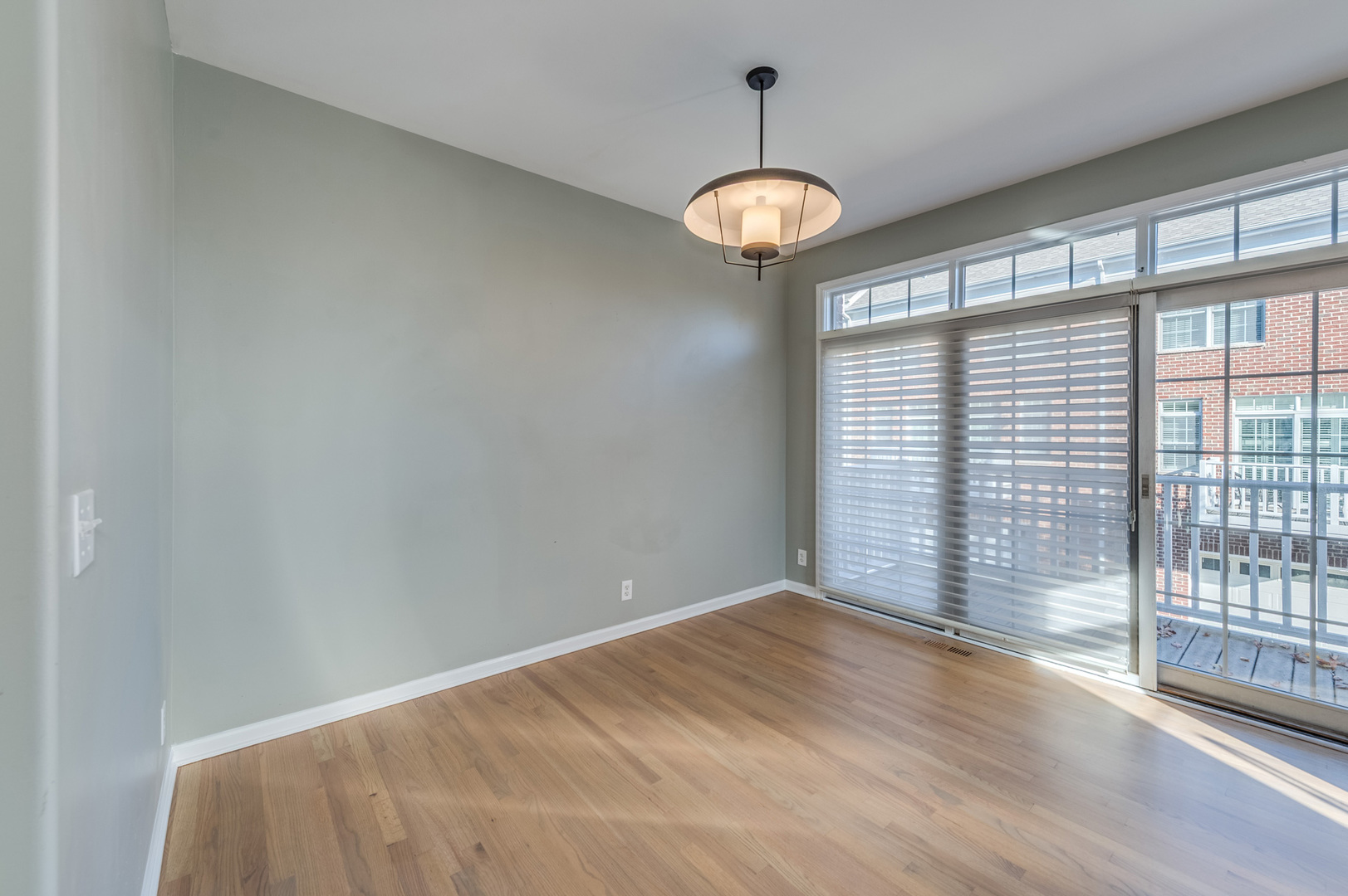 243 Boxcar Avenue Naperville, IL 60540 - Photo 16 of 29 a view of an empty room with wooden floor and a window