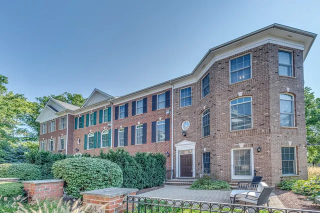 a front view of a brick house with a yard
