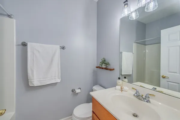a bathroom with a sink a toilet and mirror