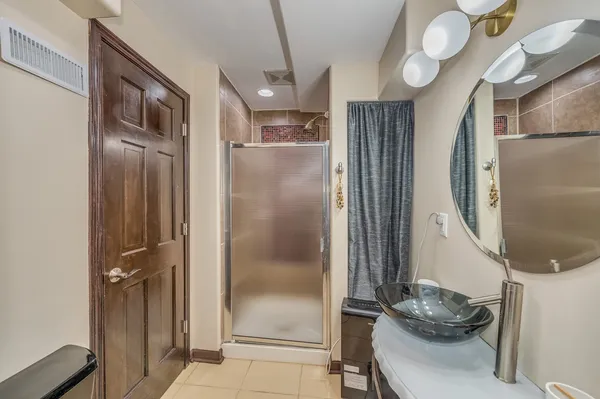 a bathroom with a mirror and a shower