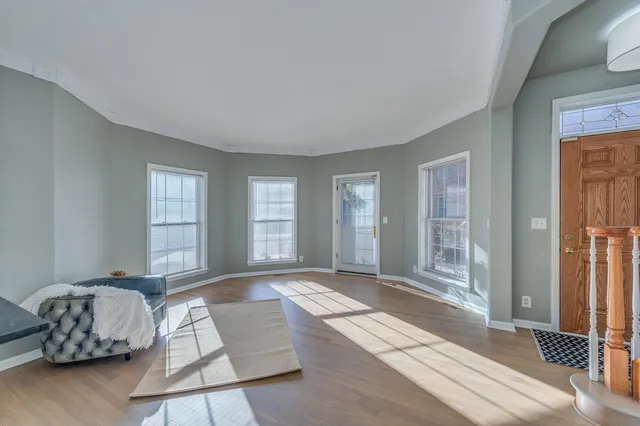 a spacious bedroom with a bed and glass window