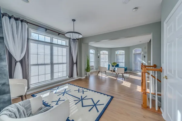 a living room with furniture a table and a large window