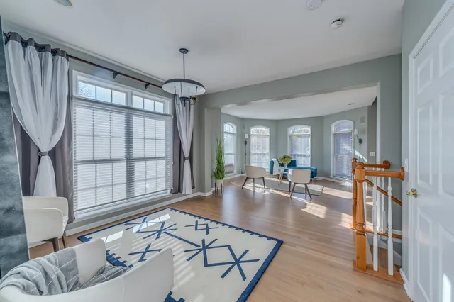 a living room with furniture a table and a large window