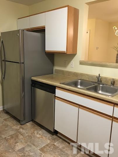 3702 Wyndcliff Court Raleigh, NC 27616 - Photo 5 of 10 a kitchen with a sink and a refrigerator
