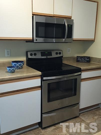 3702 Wyndcliff Court Raleigh, NC 27616 - Photo 6 of 10 a stove top oven sitting inside of a kitchen