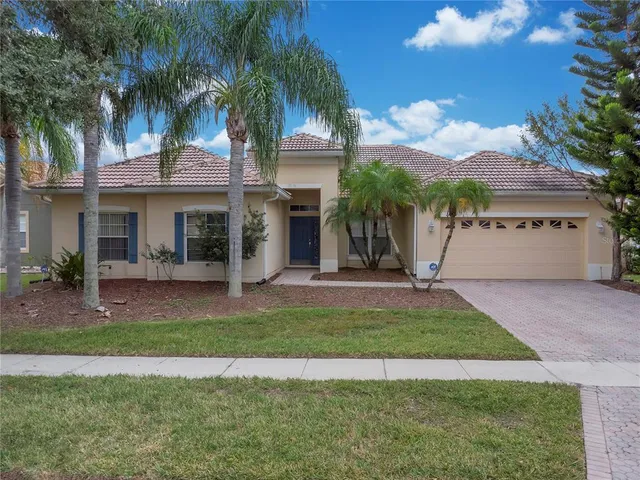 a view of a house with a yard and a garage