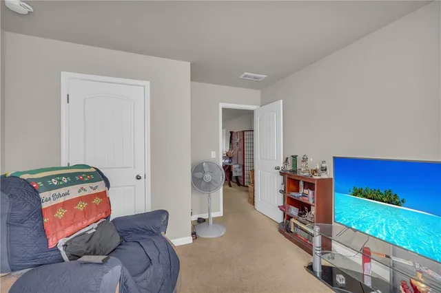 a bedroom with furniture and a book shelf
