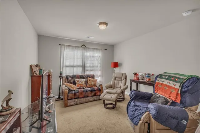 a living room with furniture a couch and a window