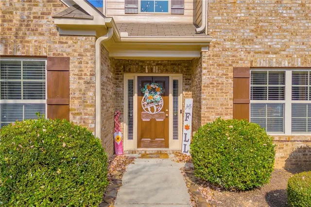 a front view of a house with a garden