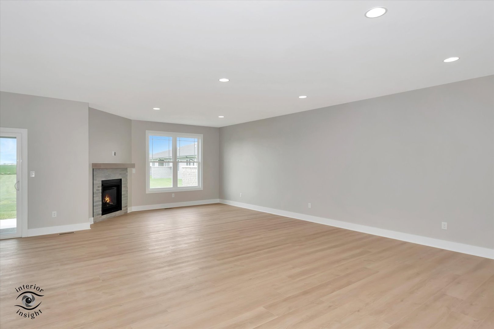 362 White Hawk Way Manteno, IL 60950 - Photo 4 of 27 an empty room with wooden floor and fireplace