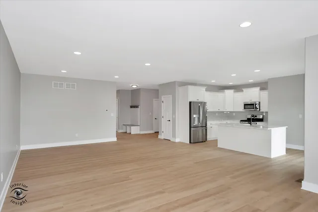 a view of a kitchen with a sink and a refrigerator