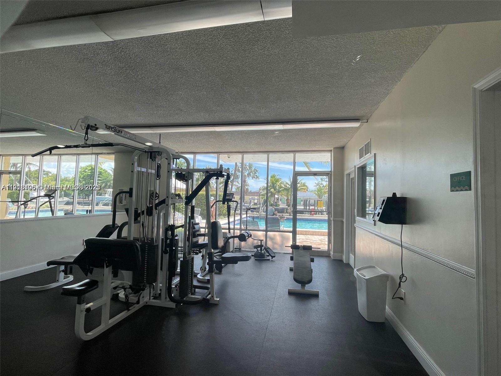 Vecino del Mar Condominium North Miami, FL 33181 - Photo 2 of 10 a view of a room with gym equipment