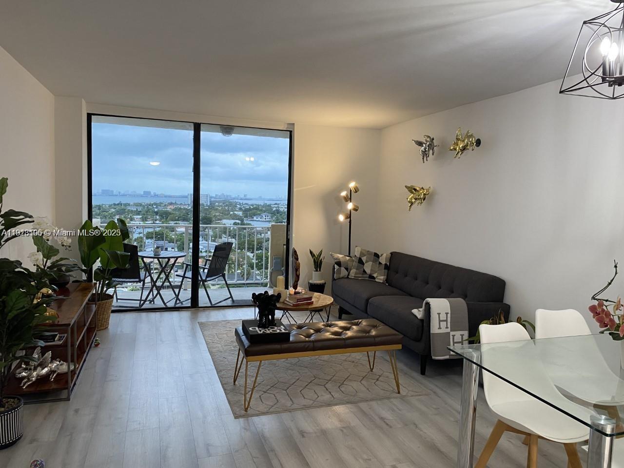 Vecino del Mar Condominium North Miami, FL 33181 - Photo 6 of 10 a living room with furniture and a large window