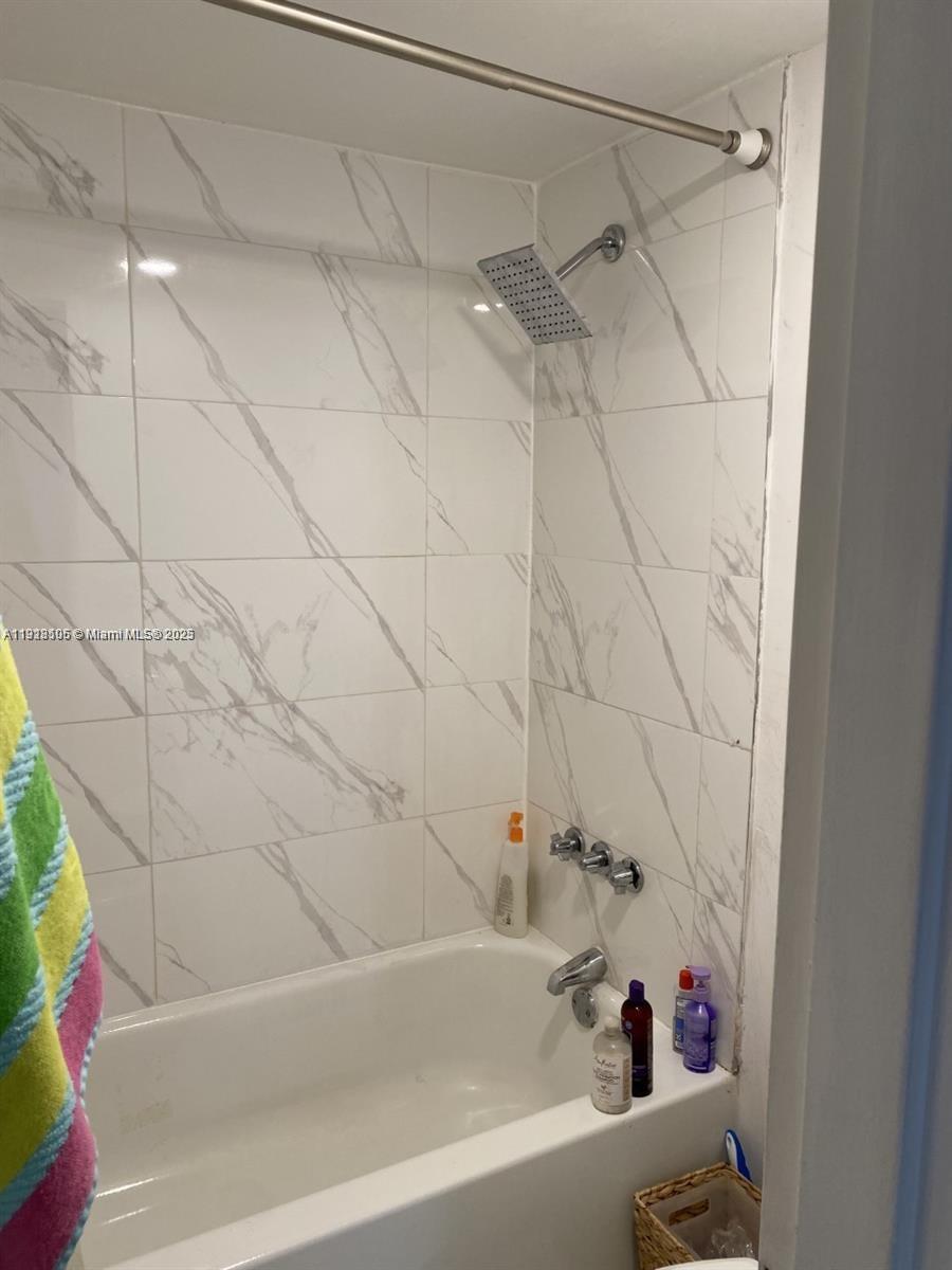 Vecino del Mar Condominium North Miami, FL 33181 - Photo 8 of 10 a bathroom with a bathtub and shower
