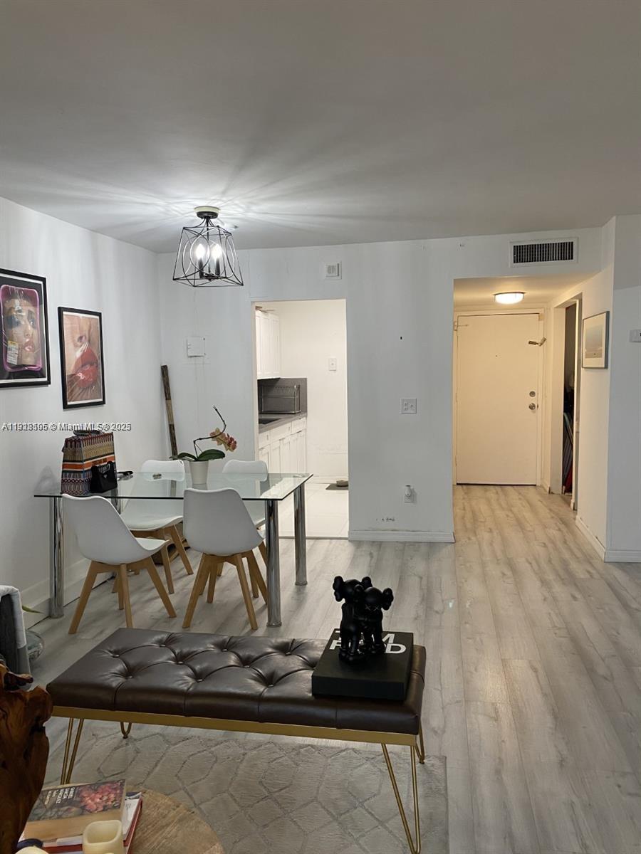 Vecino del Mar Condominium North Miami, FL 33181 - Photo 10 of 10 a living room with hard wood flooring and a couch