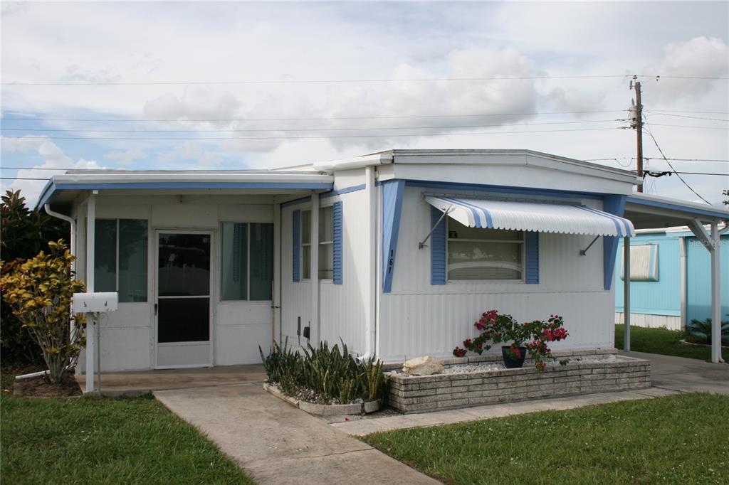 1800 Englewood Road, Unit 161 Englewood, FL 34223 - Photo 1 of 1 a front view of a house with a yard