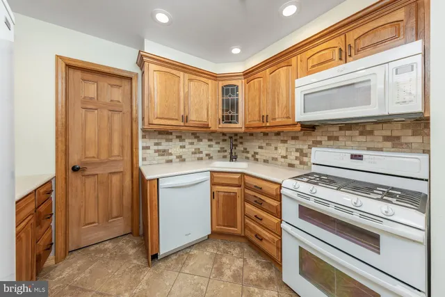 a kitchen with granite countertop cabinets stainless steel appliances and a sink