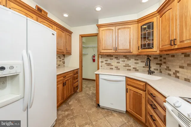 a kitchen with granite countertop a sink stove and cabinets