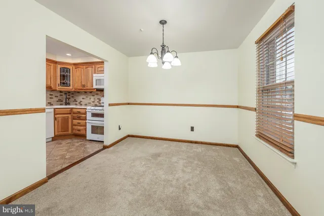 a view of a room with a ceiling fan