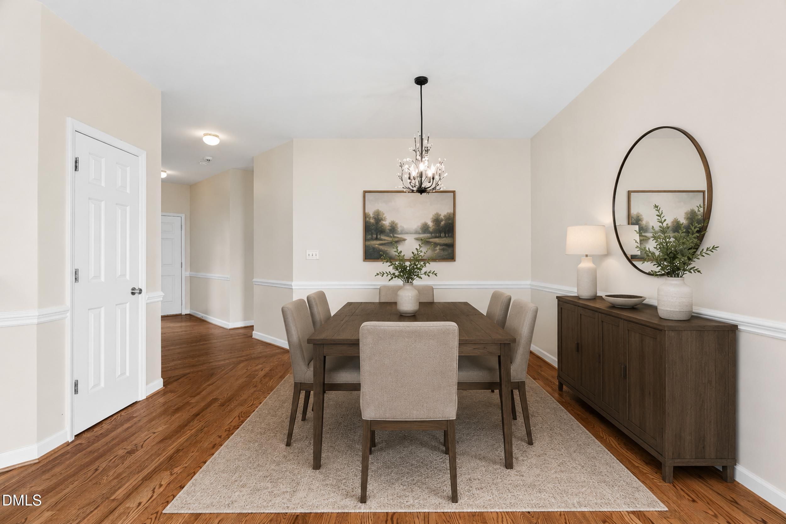 744 Seastone Street Raleigh, NC 27603 - Photo 13 of 53 a dining room with furniture a rug and a chandelier