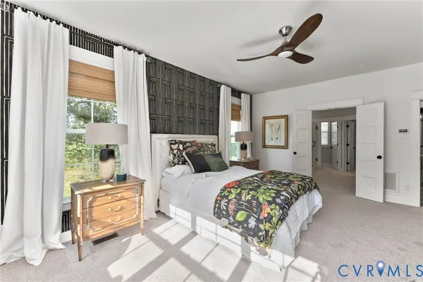 a bedroom with a bed a dresser and a window