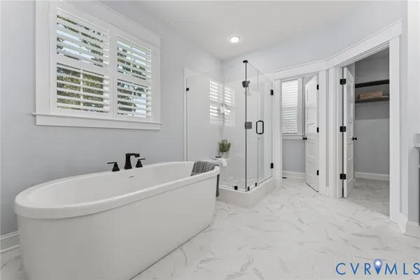 a bathroom with a bathtub a shower and a sink