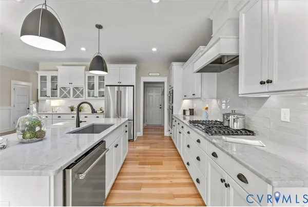 a large kitchen with stainless steel appliances kitchen island a large counter space a sink and cabinets