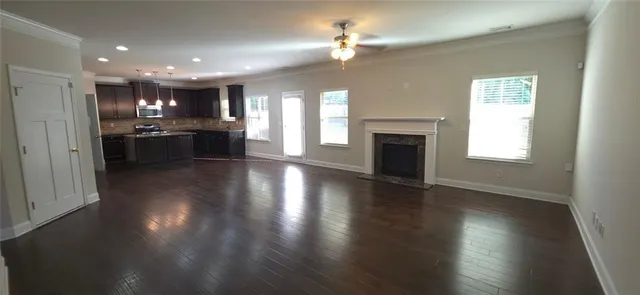 an open kitchen view with fireplace and wooden floor