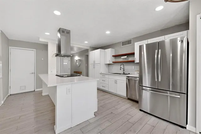 a kitchen with granite countertop a sink stove and refrigerator