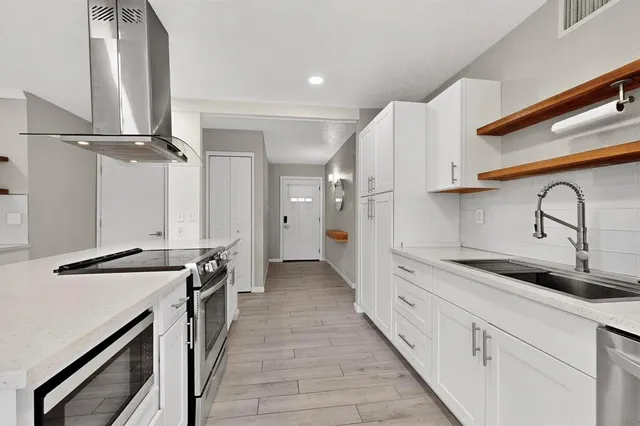 a kitchen with a stove and a refrigerator