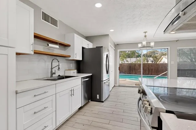 a view of a kitchen with furniture and wooden floor