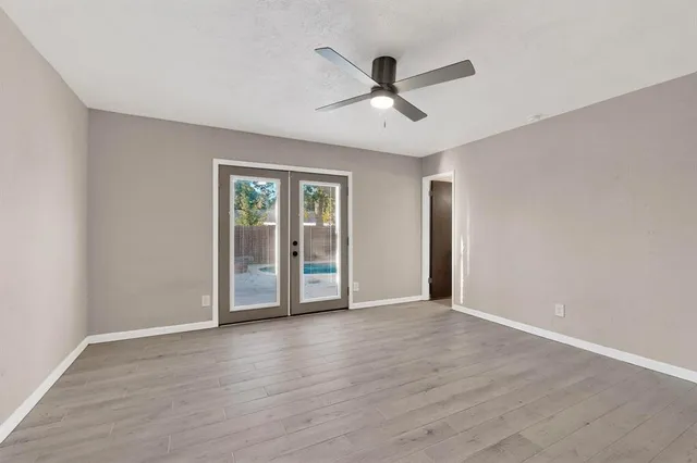 a view of an empty room with wooden floor
