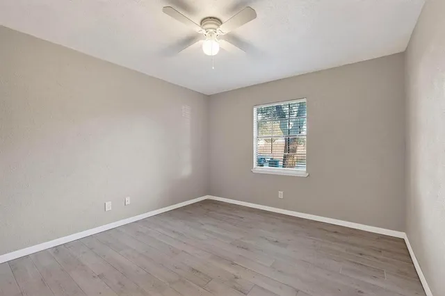 a view of an empty room with a ceiling fan