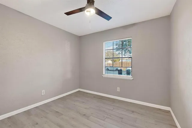 a view of an empty room and wooden floor