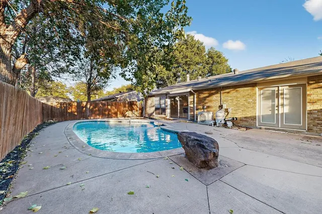 a view of backyard with wooden fence