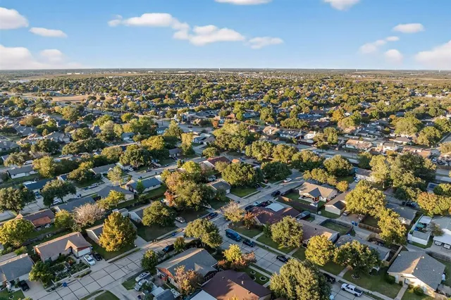 an aerial view of a house with a yard and garden
