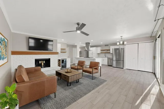 a living room with furniture fireplace and flat screen tv